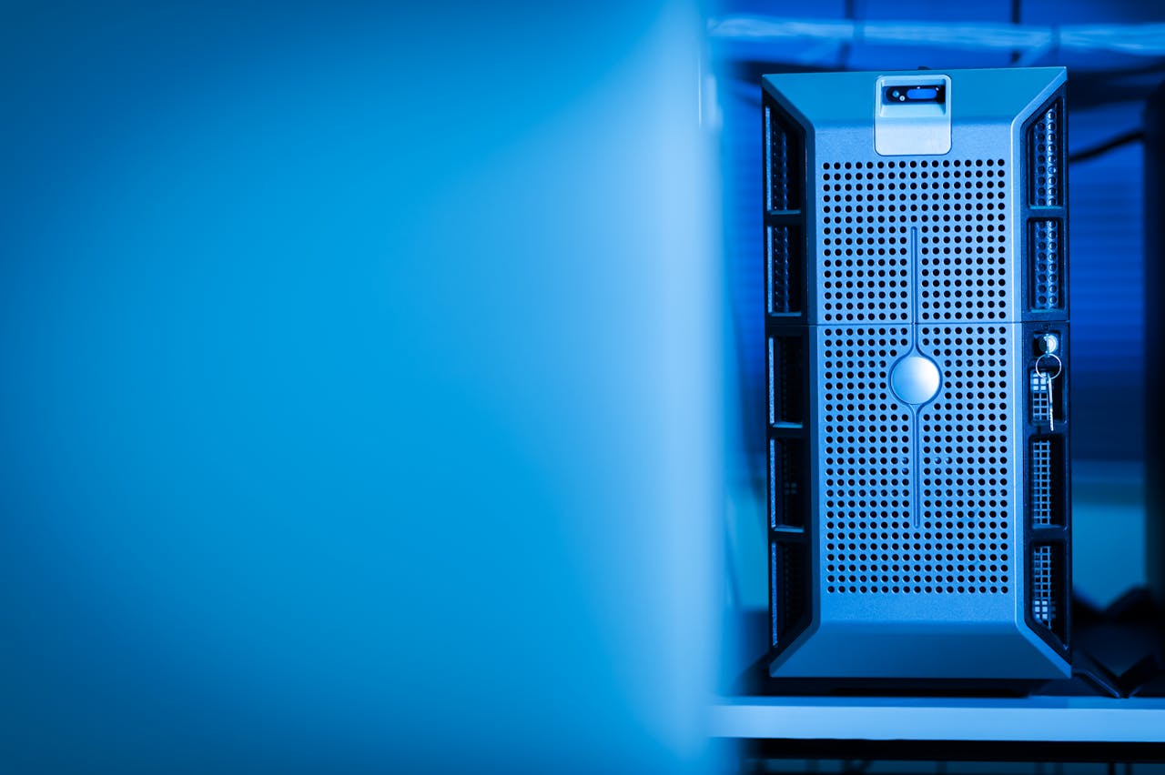 Close-up of a modern server unit in a blue-lit data center environment.